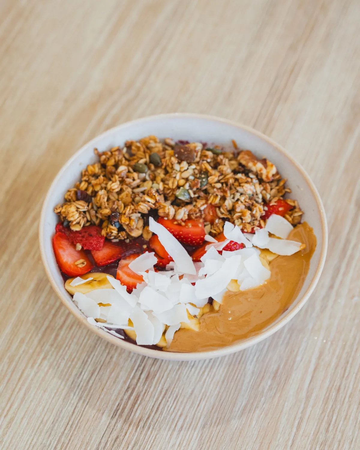 Açaí bowl with strawberries, banana, coconut and granola